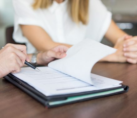 hands-male-executive-showing-contract-female-partner-meeting