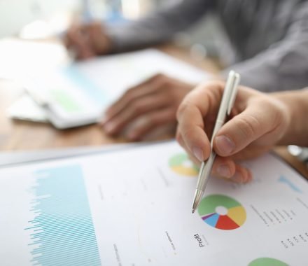 two-businessman-hold-arms-financial-papers